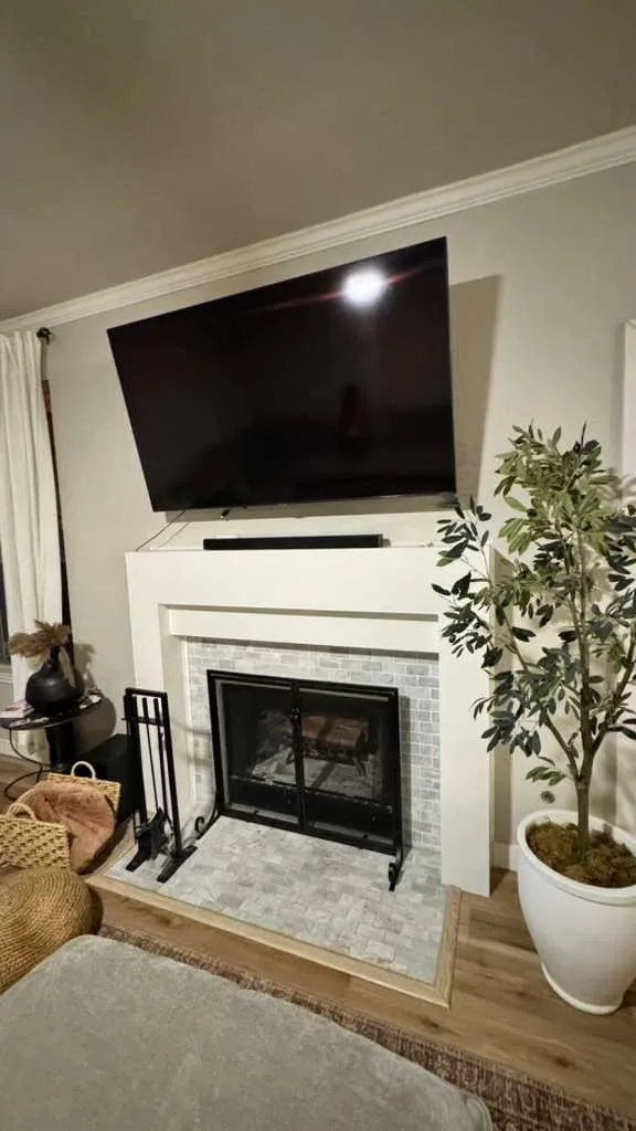 Refreshed fireplace with a new white surround and tiled hearth